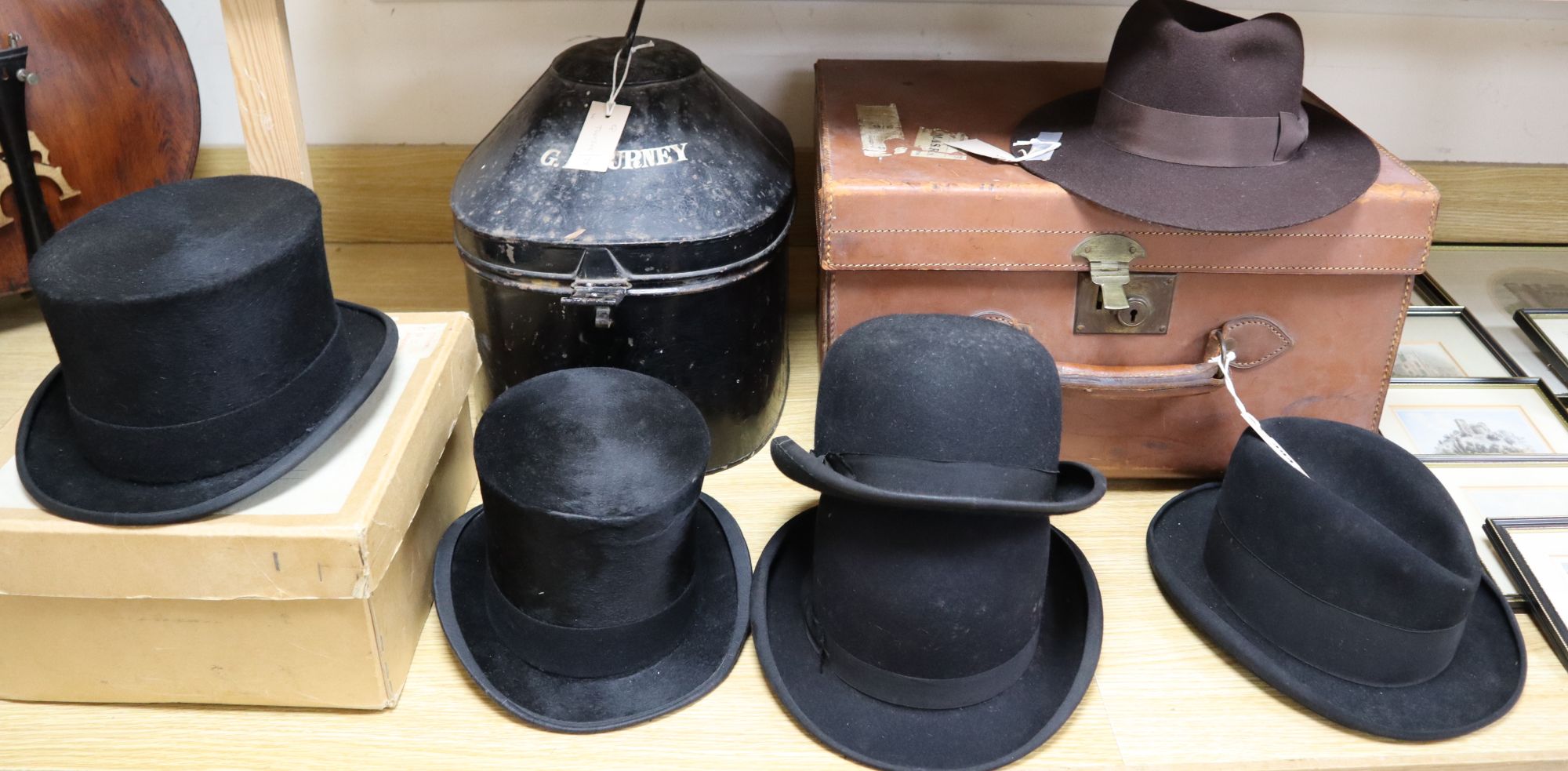 A solar pith helmet in japanned metal case, a military cap, a leather dressing case and seven other gentlemens hats, 9